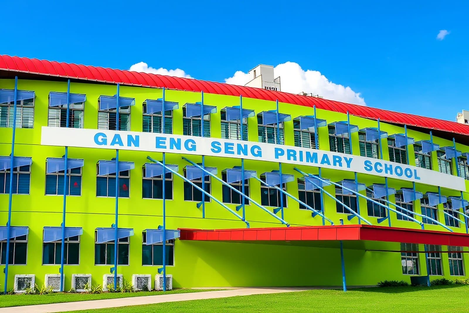 Gan Eng Seng Primary School, about 1.5 km from The River Opus Gan Eng Seng Primary School, a lime green building with a red roof and blue window awnings, under a clear blue sky